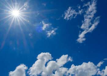Midsummer sun and blue skies, pouring down ultraviolet rays, intense sunlight.
