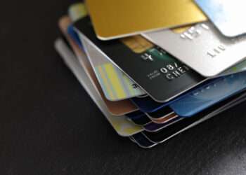 stack of multicolored credit cards on black background