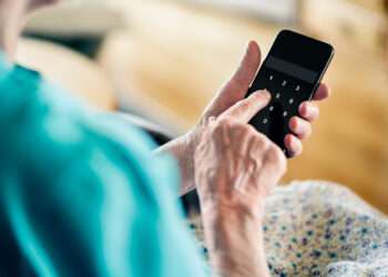 Old senior woman and phone password number code against online scam. Cyber security. Elder mature person protect bank data with pin lock. Fraud and hoax safety. Privacy from hacker and scammer online.