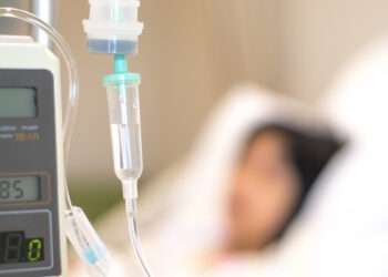 Child patient with IV line in hand sleep on hospital bed. Medical palliation healthcare concept